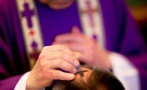 DALL·E-2024-02-13-14.44.17-An-extreme-close-up-image-capturing-a-solemn-moment-on-Ash-Wednesday-showing-a-Catholic-priest-in-traditional-purple-vestments-meticulously-applying